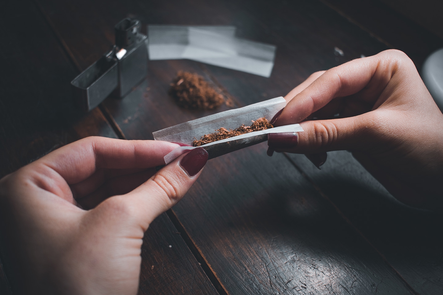 High angle shot female rolling joint kopie